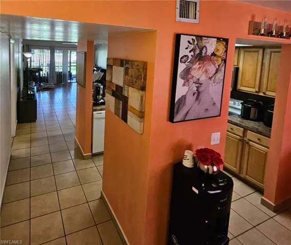 Hallway with light tile patterned flooring