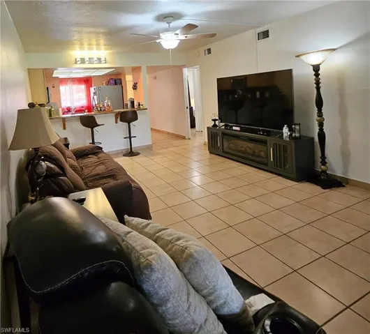 Tiled living room with ceiling fan