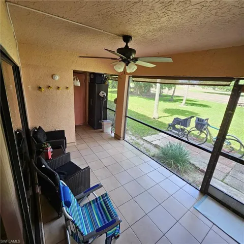 Unfurnished sunroom featuring ceiling fan