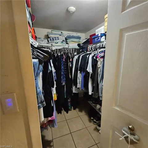 Spacious closet with light tile patterned floors