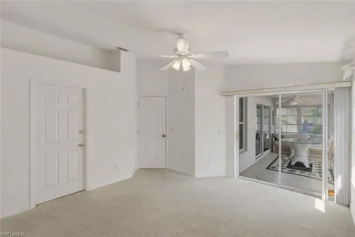 Carpeted empty room with a ceiling fan and baseboards