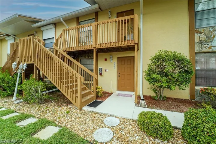 Entrance to property featuring stucco siding