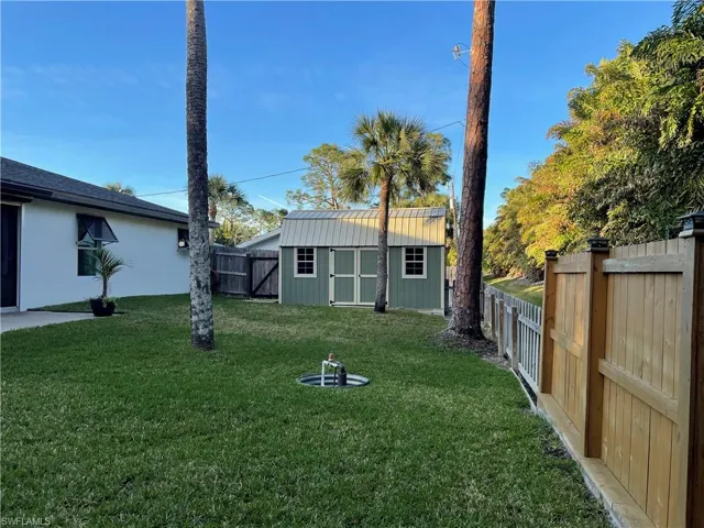View of yard with a storage unit