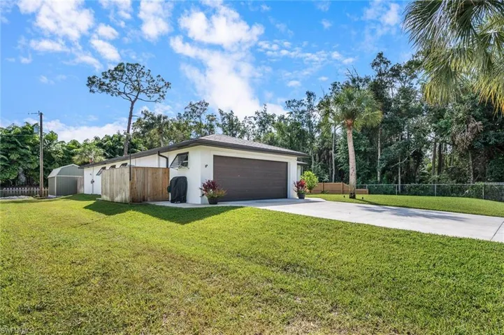 View of front facade with a front lawn and an outbuilding
