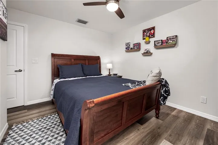 Bedroom featuring dark hardwood / wood-style flooring and ceiling fan
