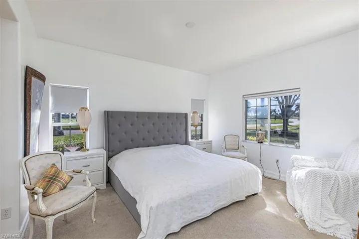 Bedroom featuring carpet flooring and baseboards