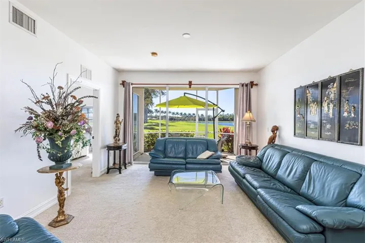 Carpeted living room with a sunroom