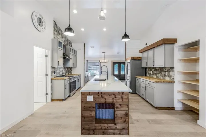 Kitchen is modern farm house.