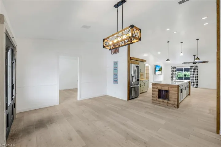 View of kitchen from entry way and dining room.