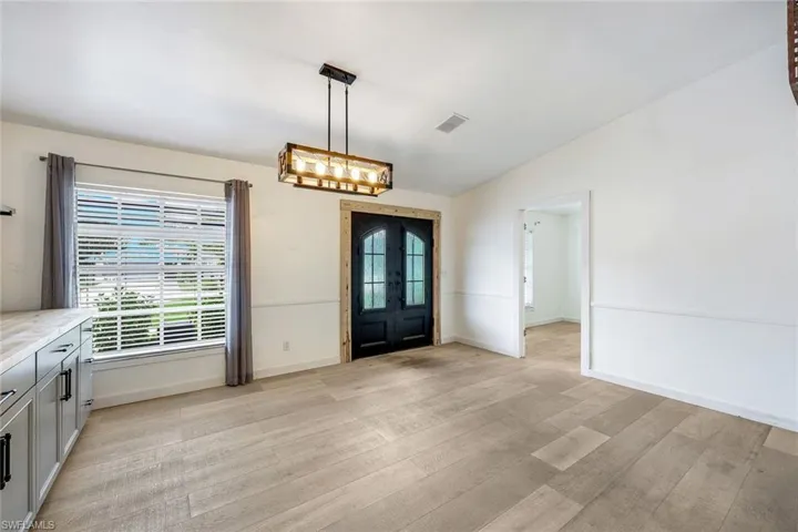 Entry way features French doors.