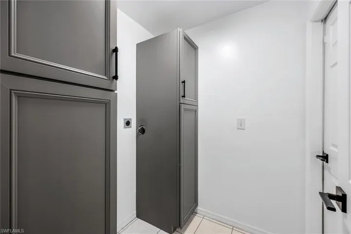Laundry room provides plenty of storage.