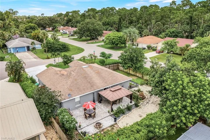 Aerial view of the back of the home. Notice the large yard.