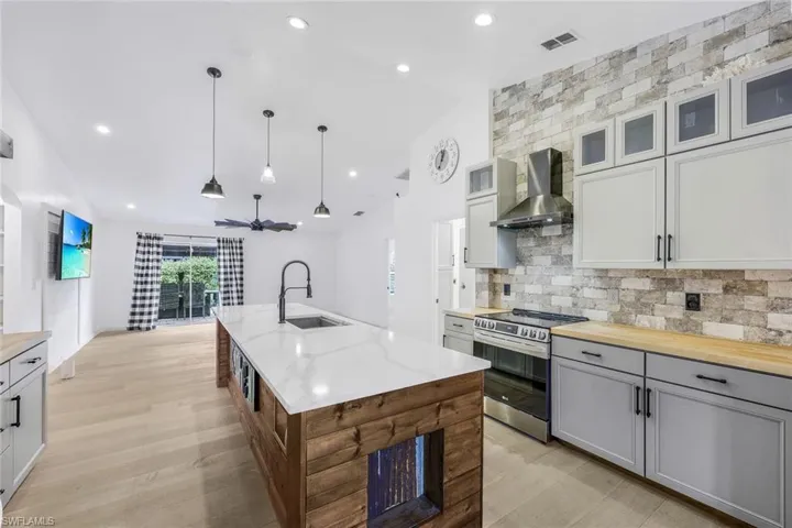 Kitchen features stainless steel appliances, custom cabinets, quartz & wood countertops, and SO much more!