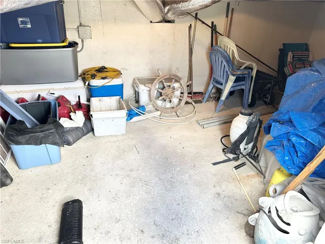 Stand up storage area under Florida room with concrete floor.