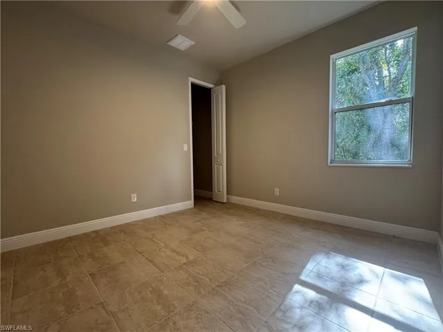 Empty room featuring ceiling fan