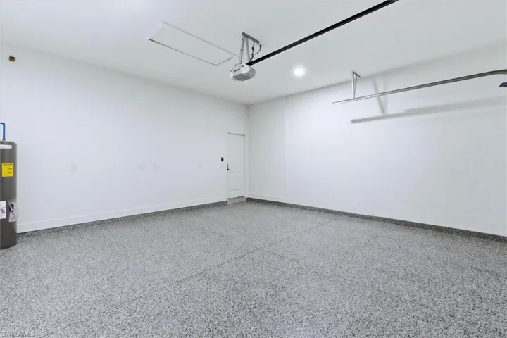Garage featuring water heater and recessed lighting
