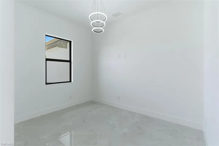 Spare room featuring baseboards