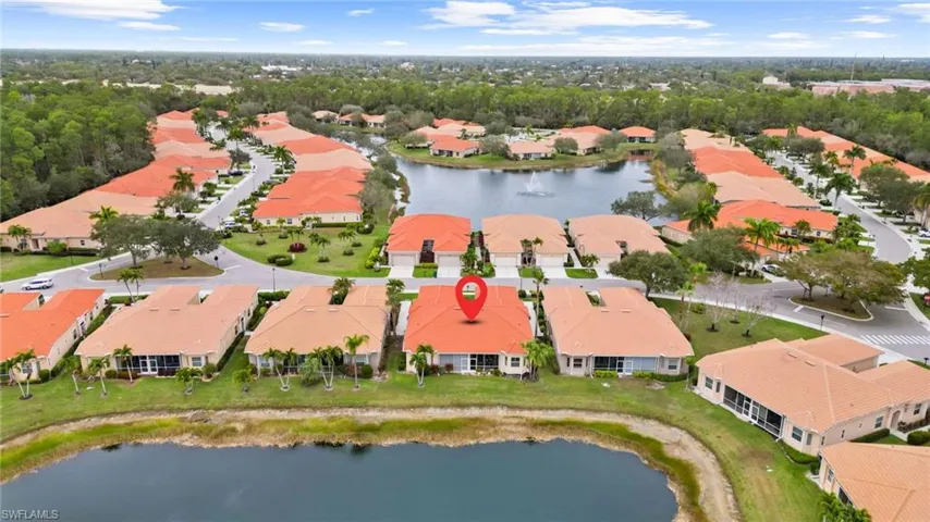 Aerial perspective of suburban area featuring a large body of water