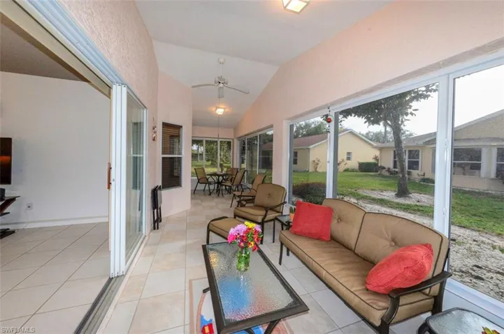 The lovely sunroom with vaulted ceiling and ceiling fan....
