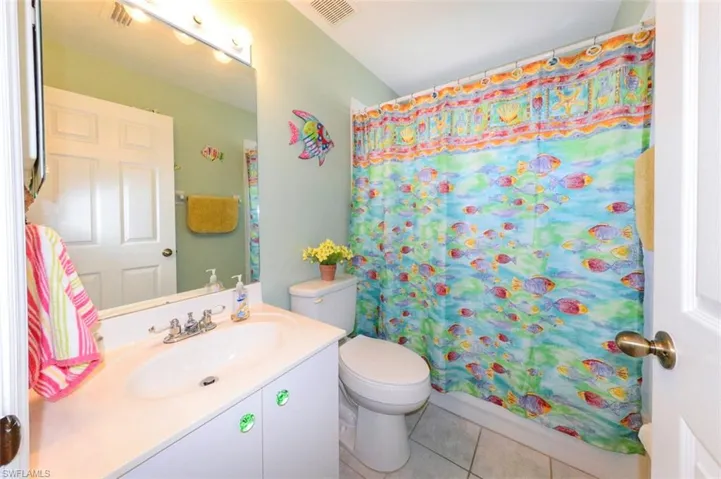 and is adjacent to the 2nd full bath with vanity, commode, and tub/shower.