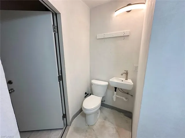 Half bath with a sink and toilet