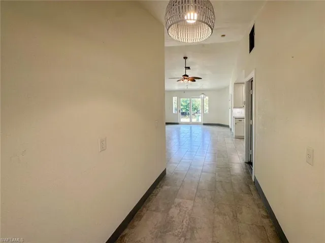Corridor featuring baseboards