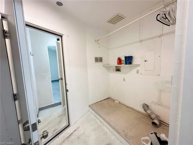 Laundry area with washer hookup and electric panel