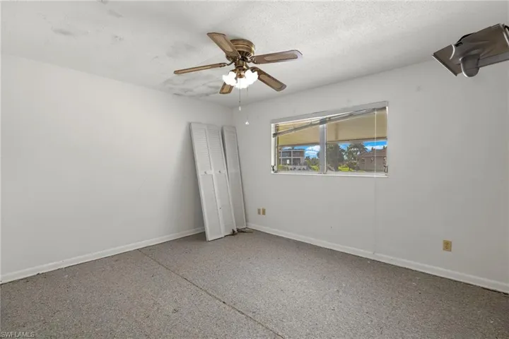 Empty room featuring a textured ceiling and ceiling fan