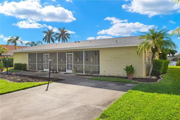 Rear view of property with a lawn