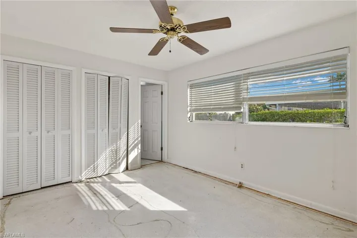 Unfurnished bedroom featuring two closets and ceiling fan