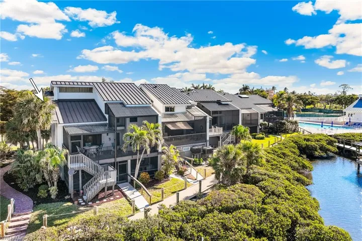 Birds eye view of back of the property with a water view