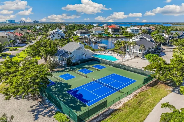Bird's eye view with a water view, tennis and pickelball