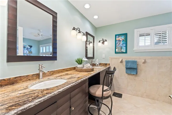 Bathroom featuring dual vanity and ceiling fan