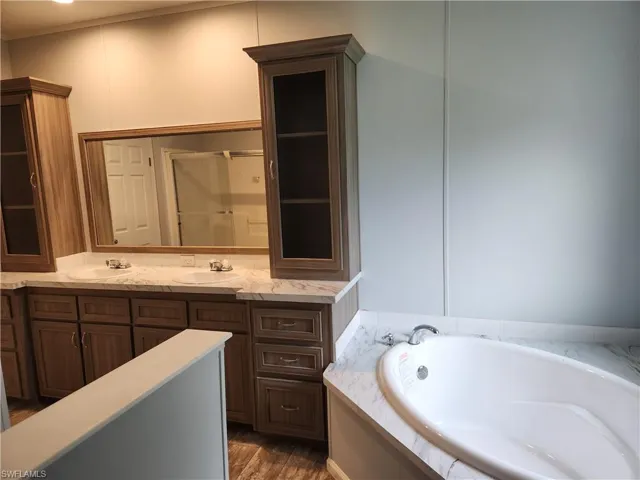 Soaking tub, dual sinks and access to laundry room