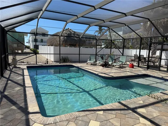 View of pool with a lanai and a patio area