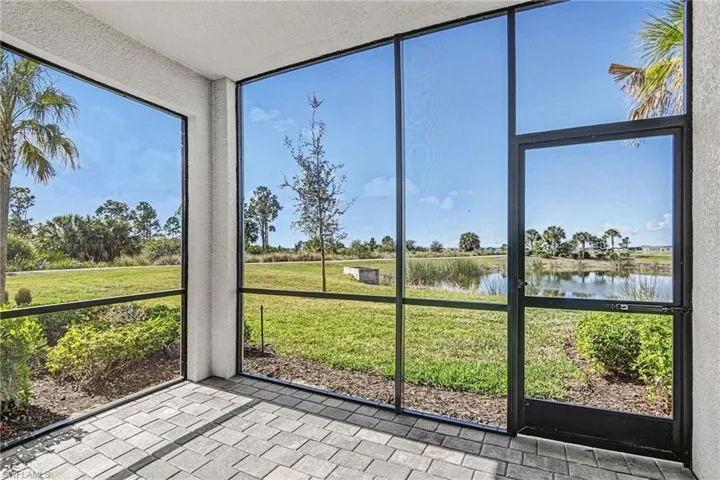 Unfurnished sunroom featuring a water view