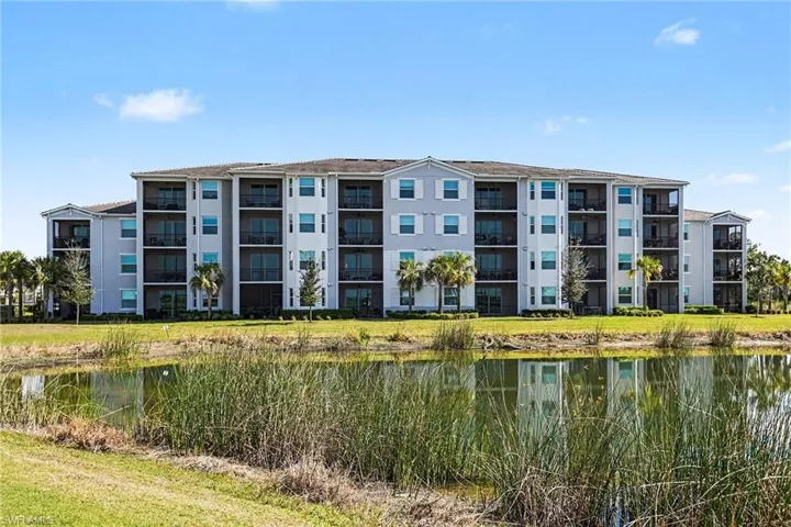 View of apartment building / complex featuring a water view