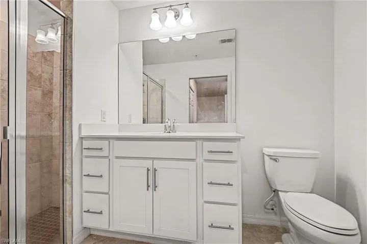 Full bathroom with a shower stall and vanity