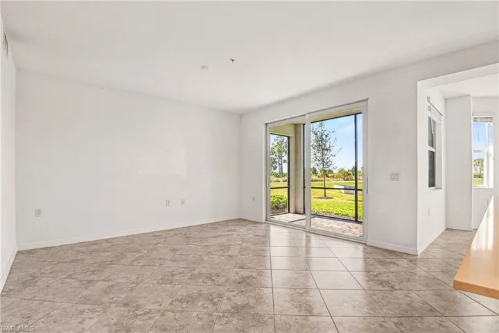 Unfurnished room featuring healthy amount of natural light and light tile patterned flooring