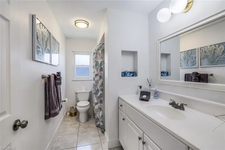 Bathroom with tile floors, vanity, and toilet
