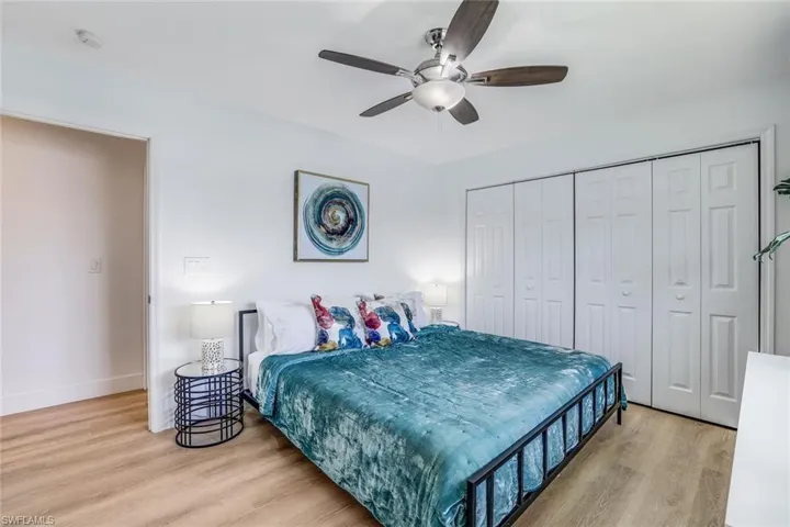 Bedroom with ceiling fan, a closet, and light hardwood / wood-style flooring