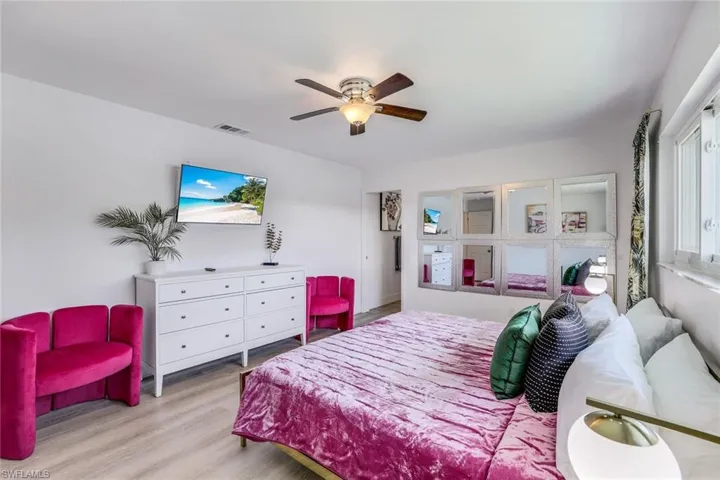 Bedroom featuring hardwood / wood-style flooring and ceiling fan