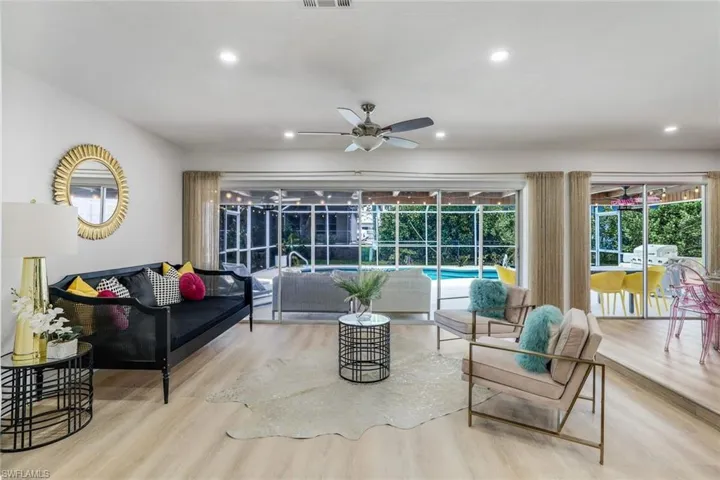 Living room featuring ceiling fan and light wood-type flooring