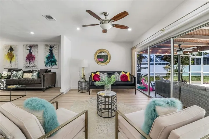 Living room featuring ceiling fan and hardwood / wood-style floors