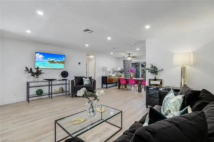 Living room with ceiling fan and light wood-type flooring
