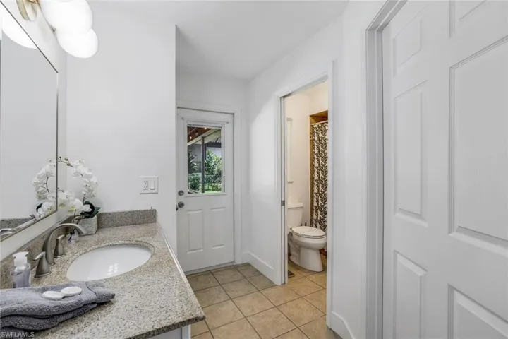 Bathroom with tile floors, toilet, and vanity