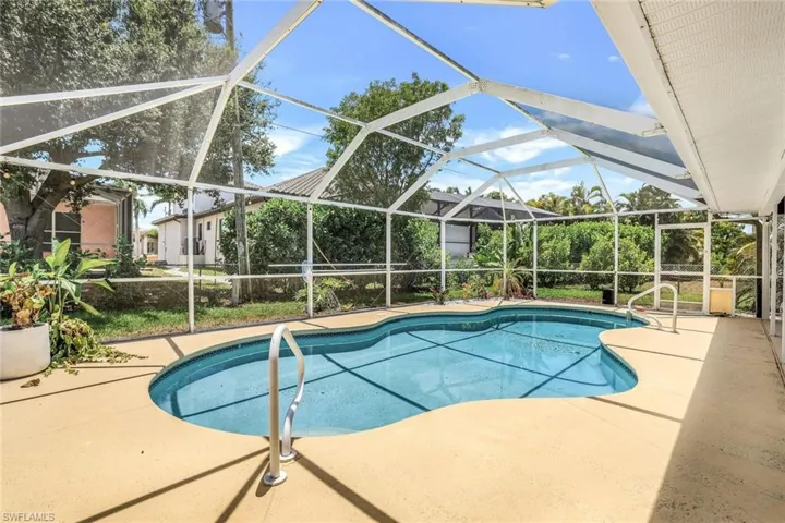View of swimming pool with a patio and a lanai