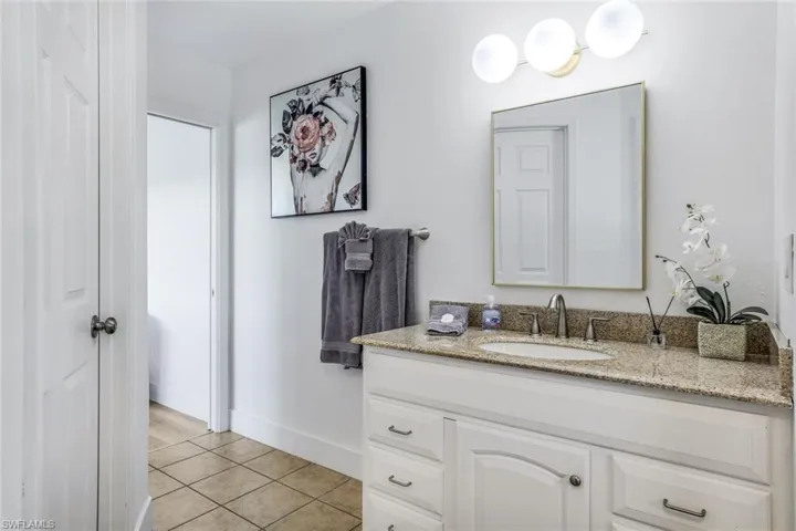 Bathroom featuring tile flooring and vanity