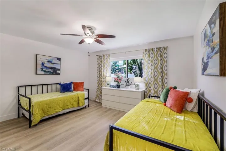 Bedroom with light hardwood / wood-style floors and ceiling fan