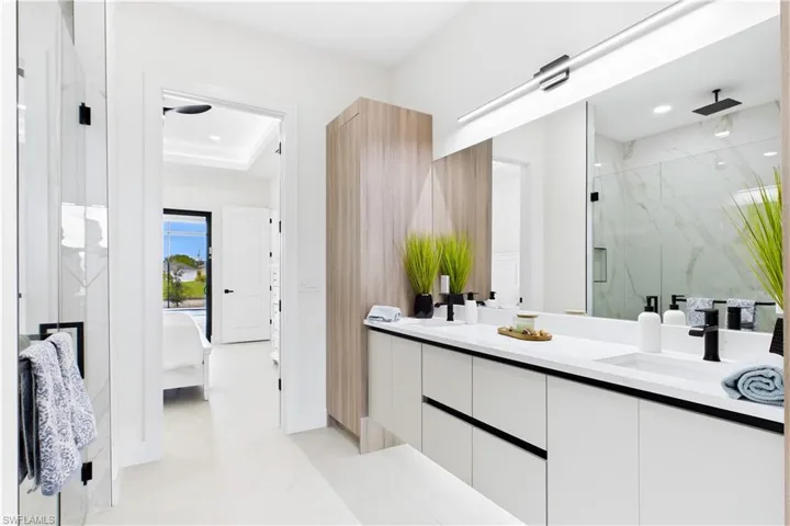 Dual vanity with integrated sinks, matte black fixtures, and solid surface countertops